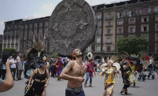 Dancers in Indigenous clothing perform marking the 700th anniversary of the founding of Tenochtitlan, known today as Mexico City, in the capital's main square, the Zocalo, Saturday, July 26, 2025. (AP Photo/Eduardo Verdugo)