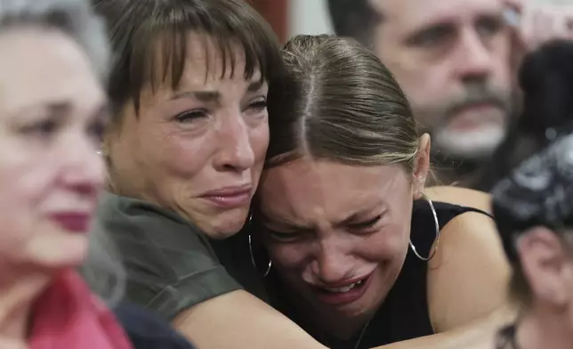 Dylan Mortensen gets a hug after speaking at the sentencing hearing of Bryan Kohberger at the Ada County Courthouse, for his sentencing hearing, Wednesday, July 23, 2025, in Boise, Idaho, for brutally stabbing four University of Idaho students to death nearly three years ago. (AP Photo/Kyle Green, Pool)