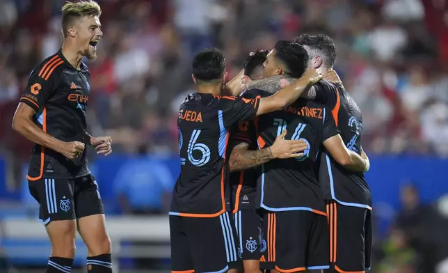 New York City FC defender Strahinja Tanasijević, left, celebrates with teammates after forward Alonso Martínez (16) scored a goal against FC Dallas during the second half of an MLS soccer match Friday, July 25, 2025 in Frisco, Texas. (AP Photo/Julio Cortez)