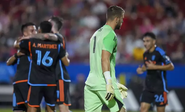FC Dallas goalkeeper Maarten Paes, center, walks by as New York City FC players celebrate a goal by forward Alonso Martínez (16) during the second half of an MLS soccer match Friday, July 25, 2025 in Frisco, Texas. (AP Photo/Julio Cortez)