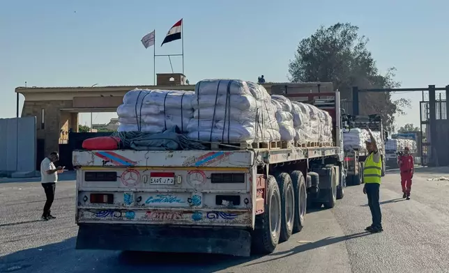 Trucks carrying humanitarian aids enter the Rafah crossing between Egypt and the Gaza Strip, Sunday, July 27, 2025. (AP Photo/Mohamed Arafat)
