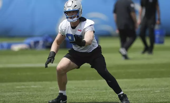 FILE - Detroit Lions defensive end Aidan Hutchinson runs a drill during an NFL football practice in Allen Park, Mich., May 30, 2025. (AP Photo/Paul Sancya, file)