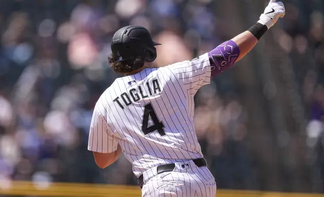 Colorado Rockies' Michael Toglia gestures to the bullpen as he circles the bases after hitting a two-run home run off Chicago White Sox relief pitcher Dan Altavilla in the fifth inning of a baseball game Sunday, July 6, 2025, in Denver. (AP Photo/David Zalubowski)