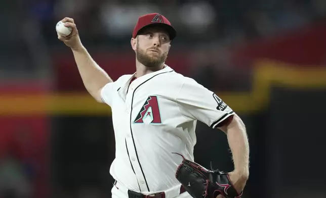 Arizona Diamondbacks starting pitcher Merrill Kelly throws against the St. Louis Cardinals during the first inning of a baseball game Sunday, July 20, 2025, in Phoenix. (AP Photo/Ross D. Franklin)