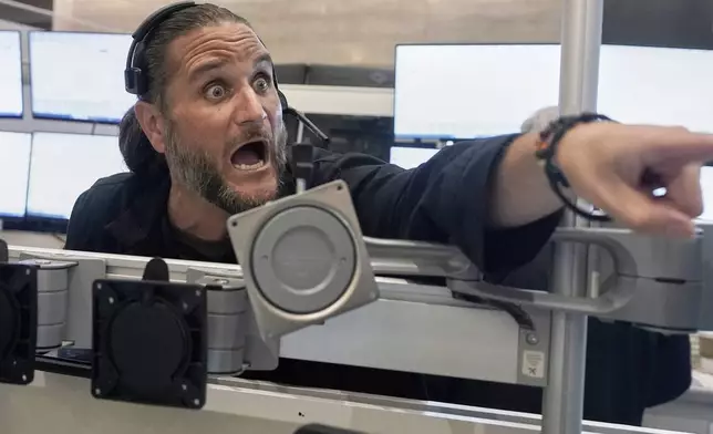 Options trader Chris Dattolo works on the floor of the New York Stock Exchange, Tuesday, July 29, 2025. (AP Photo/Richard Drew)