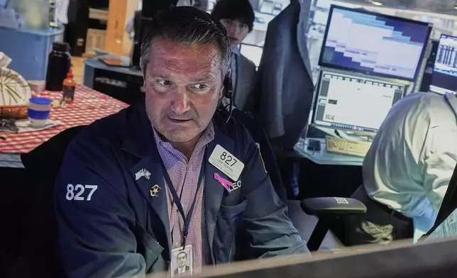 Trader Leon Montana works on the floor of the New York Stock Exchange, Tuesday, July 29, 2025. (AP Photo/Richard Drew)