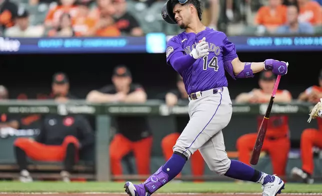 Colorado Rockies' Ezequiel Tovar (14) strikes out swinging during the first inning of a baseball game against the Baltimore Orioles, Saturday, July 26, 2025, in Baltimore. (AP Photo/Stephanie Scarbrough)