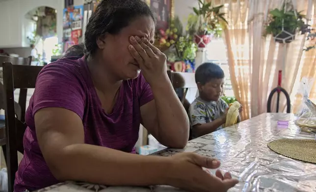 Maria sobs as she recounts how scared and anxious she is for her children, including 4-year-old Juan, if she is taken away by ICE agents, Wednesday, June 18, 2025, while inside her home in Hidalgo County, Texas. (AP Photo/Jacquelyn Martin)