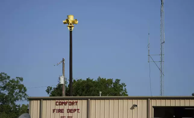 An emergency siren is visible on top of the Comfort Volunteer Fire Department in Comfort, Texas on Thursday, July 10, 2025. (AP Photo/Ashley Landis)