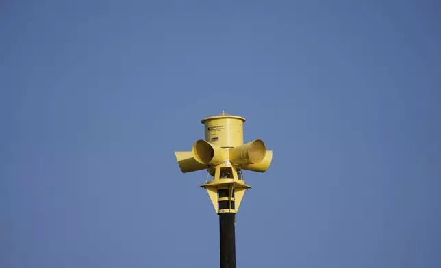 An emergency siren is visible on top of the Comfort Volunteer Fire Department in Comfort, Texas on Thursday, July 10, 2025. (AP Photo/Ashley Landis)
