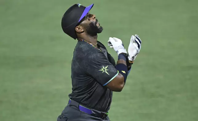 Tampa Bay Rays' Yandy Díaz reacts after hitting a grand-slam home run during the sixth inning of a baseball game against the Baltimore Orioles, Friday, July 18, 2025, in Tampa, Fla. (AP Photo/Phelan M. Ebenhack)