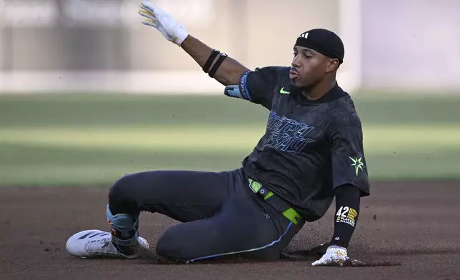 Tampa Bay Rays' Chandler Simpson slides safely into second base after hitting for a double during the first inning of a baseball game against the Baltimore Orioles, Friday, July 18, 2025, in Tampa, Fla. (AP Photo/Phelan M. Ebenhack)