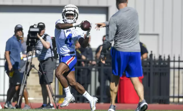 Buffalo Bills running back James Cook (4) catches a ball during practice at the team’s NFL football training camp, Wednesday, July 23, 2025, in Pittsford, N.Y. (AP Photo/Adrian Kraus)