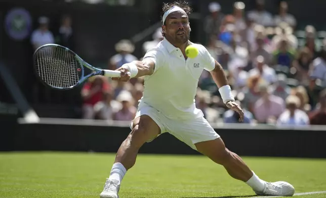 Fabio Fognini of Italy returns to Carlos Alcaraz of Spain during their first round men's singles match at the Wimbledon Tennis Championships in London, Monday, June 30, 2025. (AP Photo/Alastair Grant)