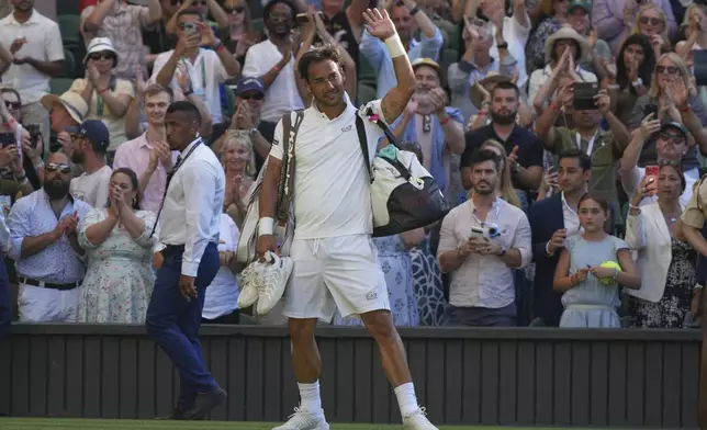 Fabio Fognini of Italy waves as he leaves the court after losing his men's singles first round match against Carlos Alcaraz of Spain was delayed at the Wimbledon Tennis Championships in London, Monday, June 30, 2025. (AP Photo/Alastair Grant)