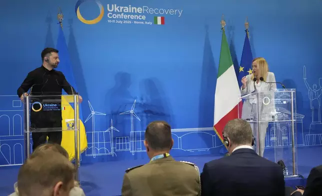 Ukraine's President Volodymyr Zelenskyy and Italian Prime Minister Giorgia Meloni speak with media reporters during the Ukraine Recovery Conference at La Nuvola convention center in Rome, Thursday, July 10, 2025. (AP Photo/Gregorio Borgia)