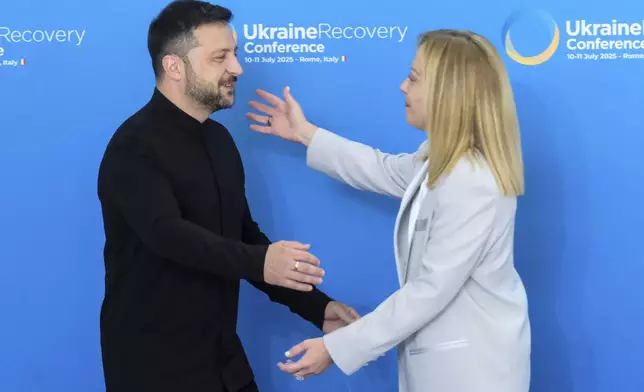 Ukrainian President Volodymyr Zelenskyy is welcomed by Italian Prime Minister Giorgia Meloni during the Ukraine Recovery Conference at La Nuvola convention center in Rome, Thursday, July 10, 2025. (Mauro Scrobogna/LaPresse via AP)