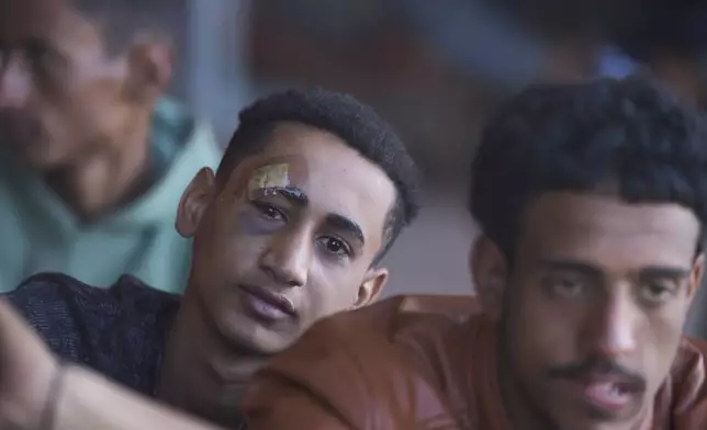 Migrants rescued south of Crete wait to be registered on their arrival at the the port of Lavrio, Greece, on Thursday, July 10, 2025. (AP Photo/Petros Giannakouris)