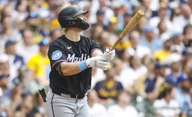 Miami Marlins' Kyle Stowers watches his home run against the Milwaukee Brewers during the third inning of a baseball game Friday, July 25, 2025, in Milwaukee. (AP Photo/Jeffrey Phelps)