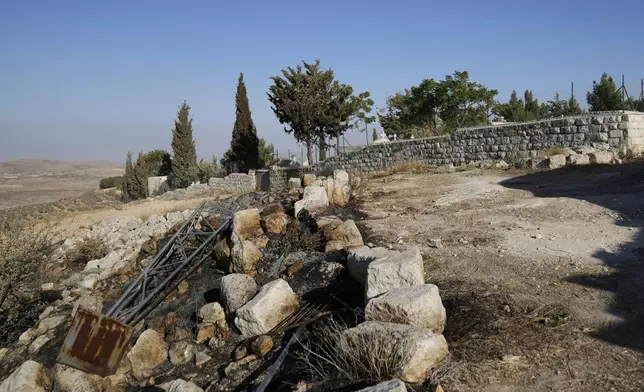 Char marks Palestinians say are from an attack by Israeli settlers are visible in the cemetery nearby the Saint George Greek Orthodox Church in the West Bank village of Taybeh, Monday, July 14, 2025. (AP Photo/Nasser Nasser)