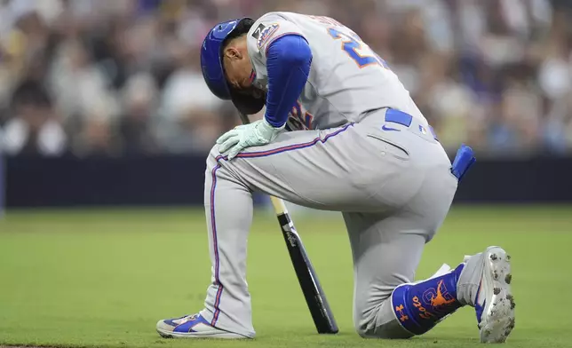 New York Mets' Juan Soto takes a moment after fouling a ball off his leg while batting during the fourth inning of a baseball game against the San Diego Padres Tuesday, July 29, 2025, in San Diego. (AP Photo/Gregory Bull)