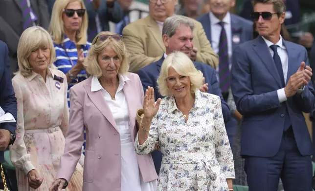 Britain's Queen Camilla waves as she arrives in the Royal Box on Centre Court for day ten at the Wimbledon Tennis Championships in London, Wednesday, July 9, 2025. (AP Photo/Kin Cheung)