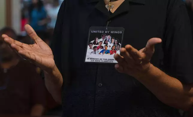 A man offer prayers for crew members of Air India flight that crashed in Ahmedabad last month during a prayer meeting at a church in Mumbai, India, Saturday, July 12, 2025. (AP Photo/ Rafiq Maqbool)