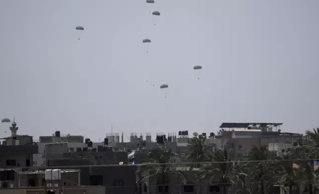 Humanitarian aid is airdropped to Palestinians over Deir al-Balah, central Gaza Strip Wednesday, July 30, 2025. (AP Photo/Abdel Kareem Hana)