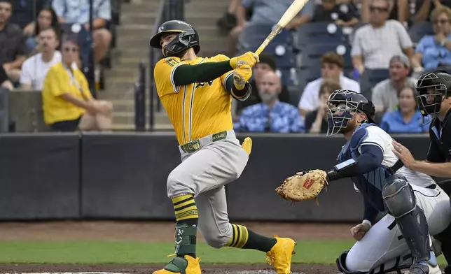 Athletics' Shea Langeliers hits a three-run home run during the first inning of a baseball game against the Tampa Bay Rays, Monday, June 30, 2025, in Tampa, Fla. (AP Photo/Jason Behnken)