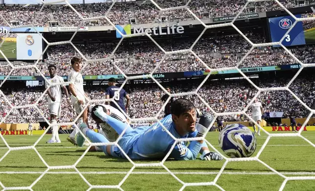 Real Madrid's goalkeeper Thibaut Courtois (1) looks back after Paris Saint-Germain's Goncalo Ramos (9) scored his side's fourth goal during the Club World Cup semifinal soccer match between PSG and Real Madrid in East Rutherford, N.J., Wednesday, July 9, 2025. (AP Photo/Seth Wenig)
