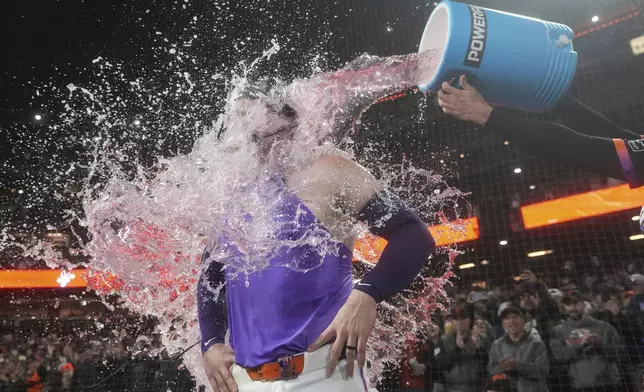 San Francisco Giants' Patrick Bailey, left, is doused by Willy Adames after hitting a three-run inside the park home run during the ninth inning of a baseball game to defeat the Philadelphia Phillies in San Francisco, Tuesday, July 8, 2025. (AP Photo/Jeff Chiu)