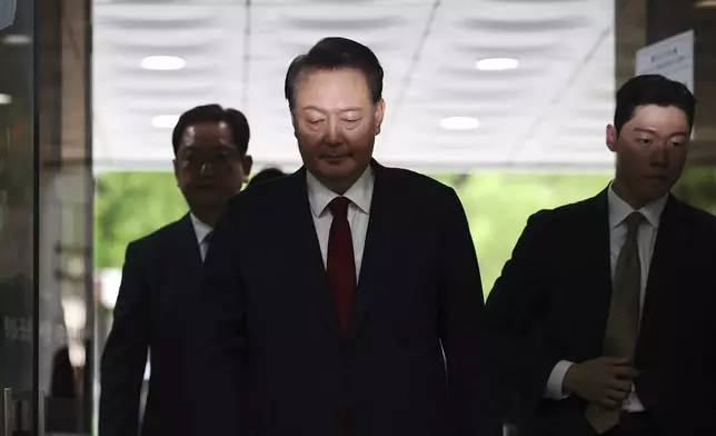 Former South Korean President Yoon Suk Yeol, centerm arrives at a court to attend a hearing to review his arrest warrant requested by special prosecutors in Seoul, South Korea Wednesday, July 9, 2025. (Kim Hong-Ji/Pool Photo via AP)