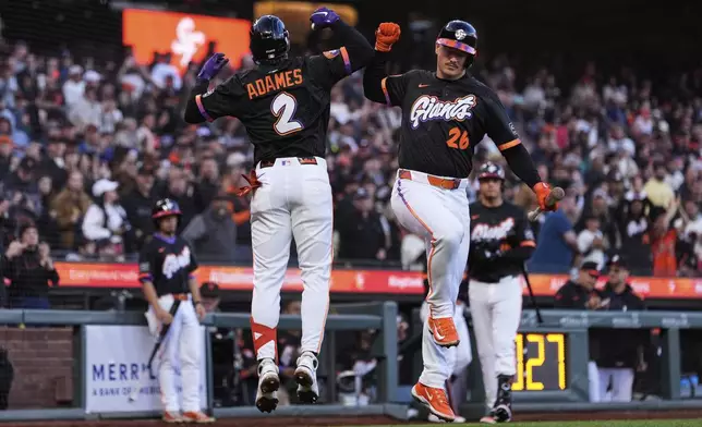 San Francisco Giants' Willy Adames (2) celebrates with Matt Chapman (26) after hitting a solo home run during the fourth inning of a baseball game against the Pittsburgh Pirates, Tuesday, July 29, 2025, in San Francisco. (AP Photo/Godofredo A. Vásquez)
