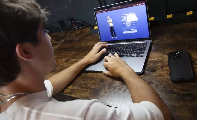 Bruce Perry, 17, demonstrates the possibilities of artificial intelligence by creating an AI companion on Character AI, Tuesday, July 15, 2025, in Russellville, Ark. (AP Photo/Katie Adkins)