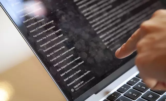 Bruce Perry, 17, shows his ChatGPT history at a coffee shop in Russellville, Ark., Tuesday, July 15, 2025. (AP Photo/Katie Adkins)