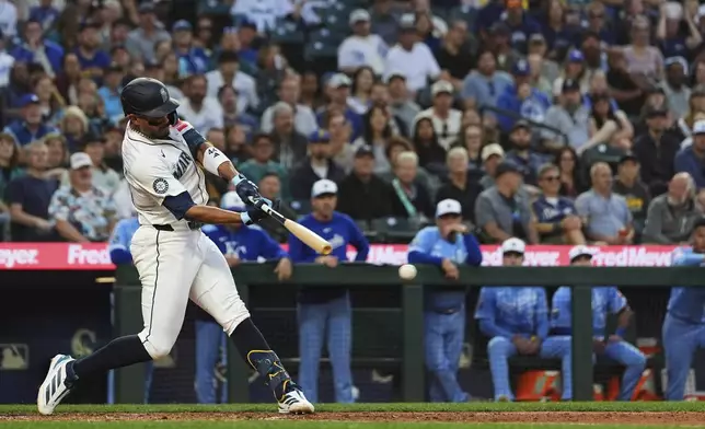 Seattle Mariners' Julio Rodriguez hits an RBI single to score Ben Williamson against the Kansas City Royals during the seventh inning of a baseball game Wednesday, July 2, 2025, in Seattle. (AP Photo/Lindsey Wasson)