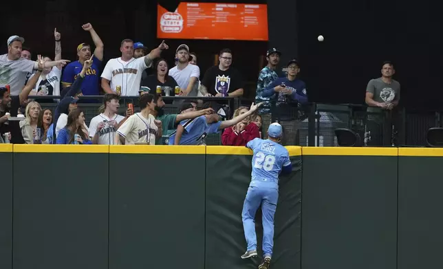 Kansas City Royals center fielder Kyle Isbel (28) watches the solo home run from Seattle Mariners' Randy Arozarena fly over the fence during the sixth inning of a baseball game Wednesday, July 2, 2025, in Seattle. (AP Photo/Lindsey Wasson)