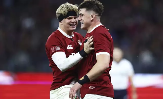Dan Sheehan, right, of the British &amp; Irish Lions is congratulated by teammate Henry Pollock after scoring his team's first try during their rugby match against the Western Force in Perth, Australia, Saturday, June 28, 2025. (AP Photo/Trevor Collens)