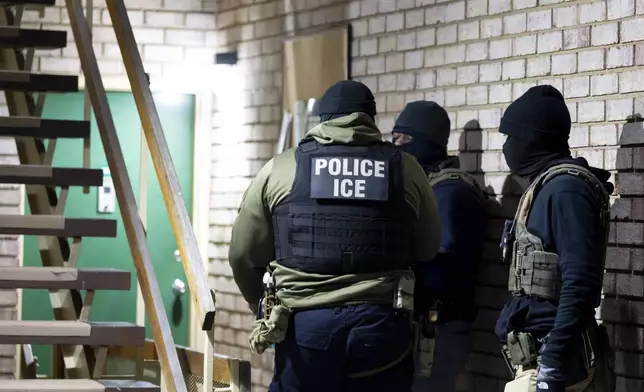 FILE - U.S. Immigration and Customs Enforcement officers wait to detain a person, Jan. 27, 2025, in Silver Spring, Md. (AP Photo/Alex Brandon, File)