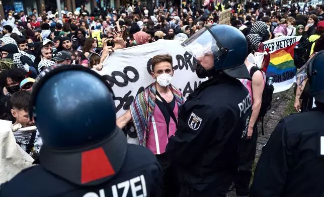 Participants in the Internationalist Queer Pride for Liberation demonstration face police officers in Berlin, on Saturday, July 26, 2025. (Michael Ukas/dpa via AP)