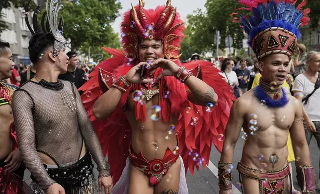 People attend the LGBTQ annual pride march in Berlin, Germany, Saturday, July 26, 2025. (AP Photo/Ebrahim Noroozi)