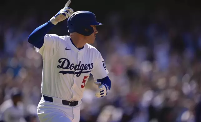 Los Angeles Dodgers' Freddie Freeman celebrates after hitting a walk-off single during the ninth inning of a baseball game against the Minnesota Twins, Wednesday, July 23, 2025, in Los Angeles. (AP Photo/Mark J. Terrill)