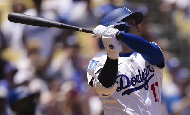 Los Angeles Dodgers' Shohei Ohtani hits a solo home run during the first inning of a baseball game against the Minnesota Twins, Wednesday, July 23, 2025, in Los Angeles. (AP Photo/Mark J. Terrill)