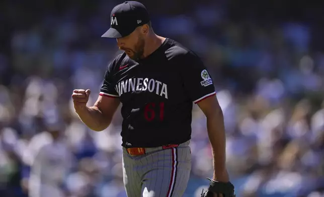 Minnesota Twins relief pitcher Brock Stewart celebrates after the eighth inning of a baseball game against the Los Angeles Dodgers, Wednesday, July 23, 2025, in Los Angeles. (AP Photo/Mark J. Terrill)