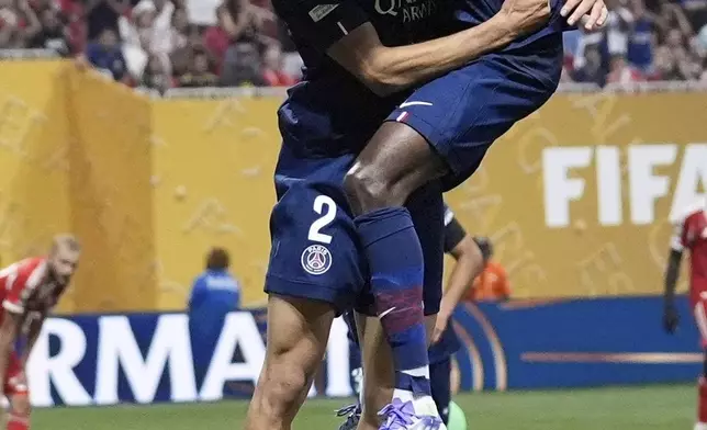 Paris Saint-Germain's Ousmane Dembele celebrates his team's second goal with Paris Saint-Germain's Achraf Hakimi during the Club World Cup quarterfinal soccer match between PSG and Bayern Munich in Atlanta, Saturday, July 5, 2025. (AP Photo/Brynn Anderson)