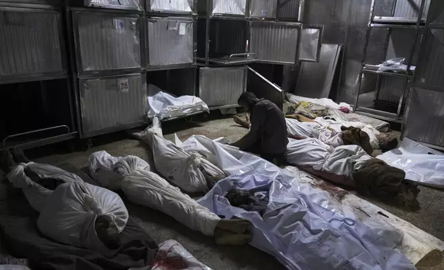 Palestinians mourn their relatives killed from an Israeli army bombardment of Gaza, at the morgue of Shifa Hospital in Gaza City Tuesday, July 22, 2025. (AP Photo/Jehad Alshrafi)