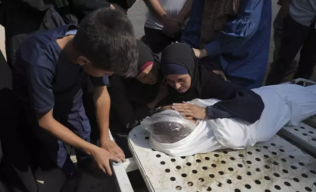 Relatives of Palestinian child Salem Hussein, 12, killed in an Israeli army bombardment of Gaza, mourn beside his body at Shifa Hospital in Gaza City on Tuesday, July 22, 2025. (AP Photo/Jehad Alshrafi)