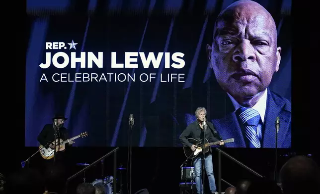 FILE - Rodney Crowell, right, performs in the Ryman Auditorium during a celebration of life marking the one-year anniversary of U.S. Rep. John Lewis's death, July 17, 2021, in Nashville, Tenn. (AP Photo/Mark Humphrey, file)