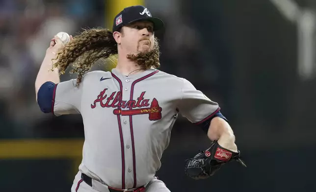 Atlanta Braves starting pitcher Grant Holmes throws to the Texas Rangers in the fourth inning of a baseball game Saturday, July 26, 2025, in Arlington, Texas. (AP Photo/Tony Gutierrez)