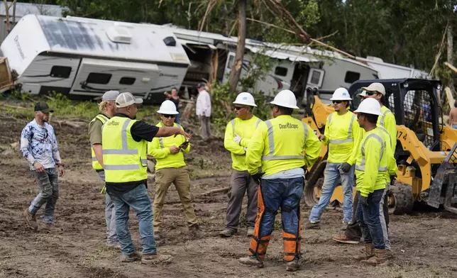 People help during clean-up efforts at Guadalupe Keys Resort, an RV park in Center Point, Texas, after flooding, Monday, July 7, 2025. (AP Photo/Ashley Landis)